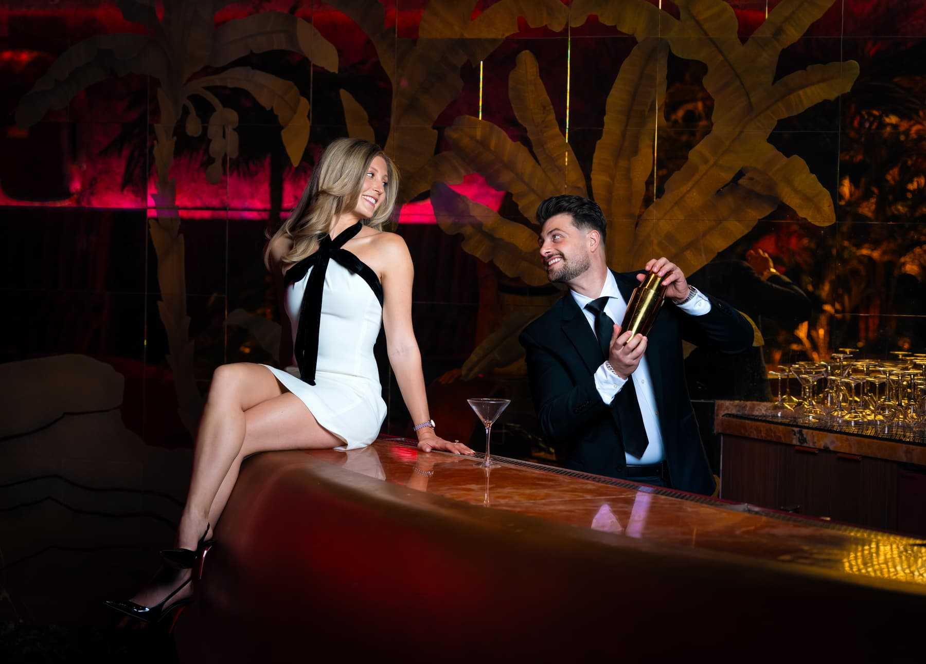 Couple posing at a bar during a couple photography session at Red Rock Casino in Las Vegas